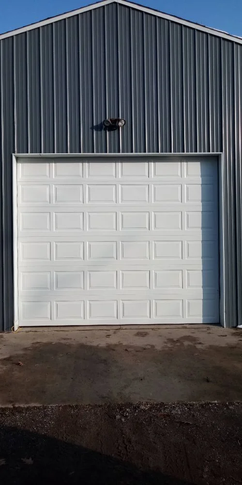 White garage door on metal commercial building