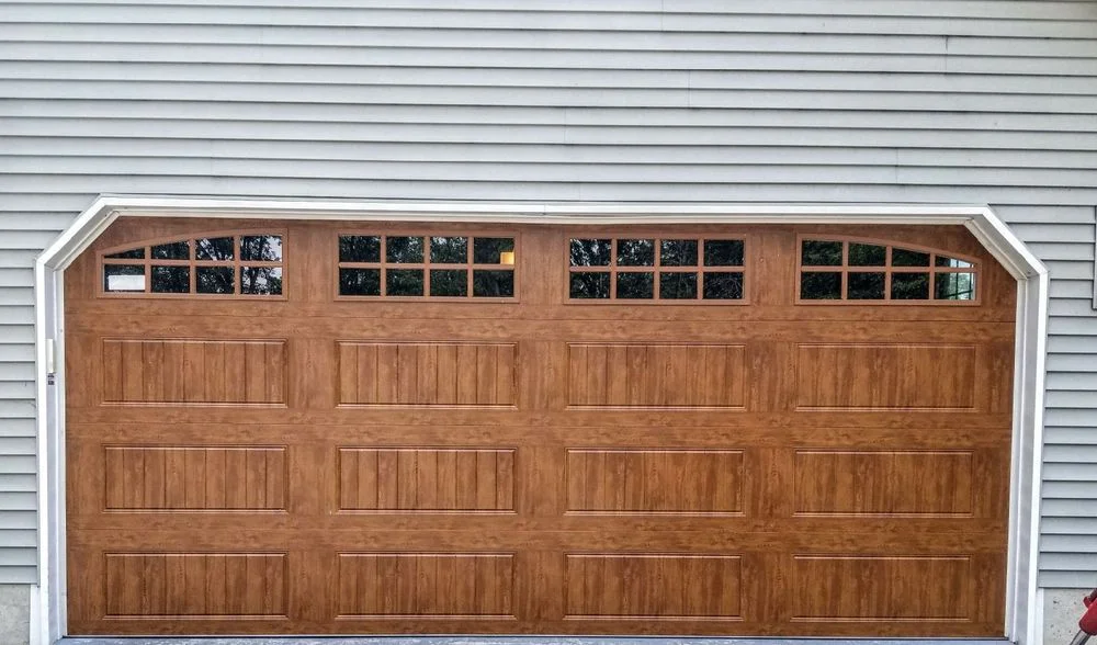 Premium wood-grain double garage door with arched windows