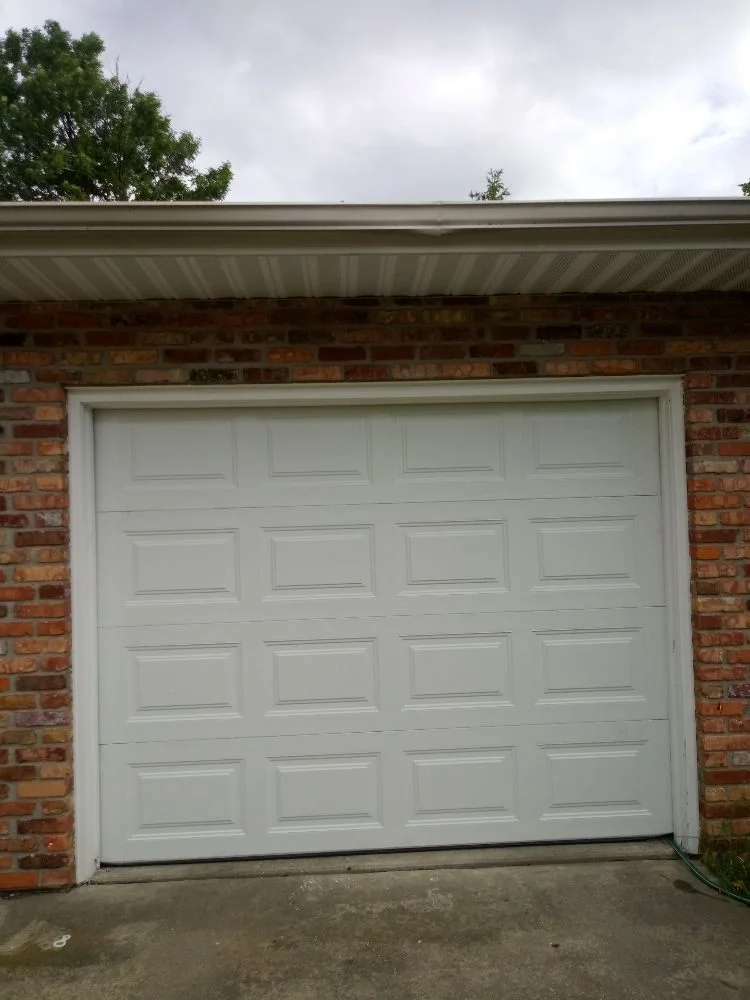 White garage door on brick home