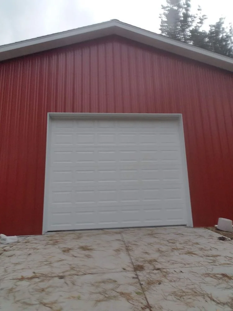 White garage door on red barn